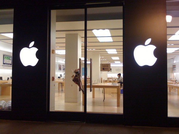 Flowers adorn an Apple Store door, hours after the world learned that Steve Jobs had died. [Blake Patterson]
