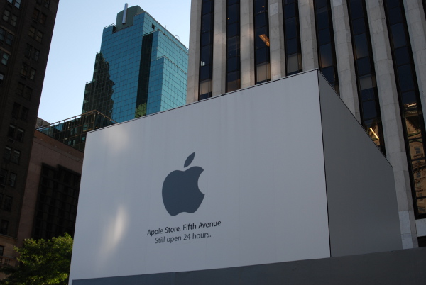 Apple's flagship store in New York is coincidentally enshrined for renovations. The somber gray covering the once mighty cube is seemingly appropriate for the people coming not to shop but to remember Steve Jobs.  [Tim Conneally]