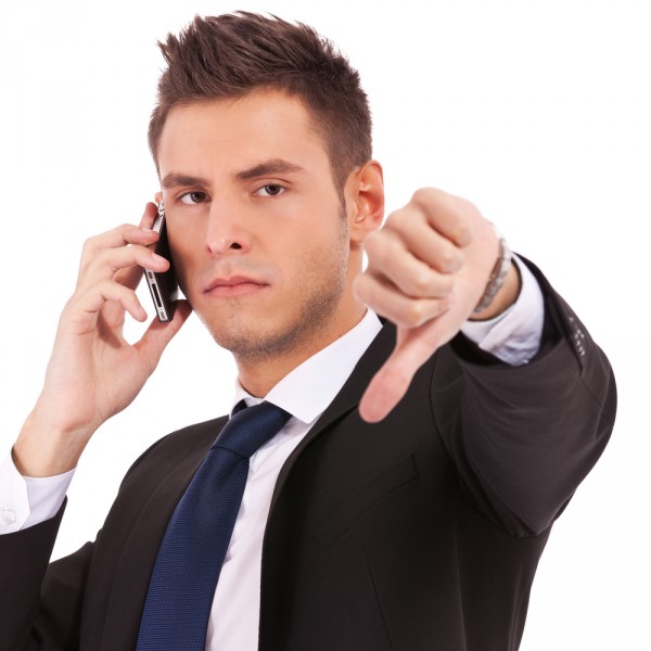 businessman thumbs down angry suit cell phone iPhone