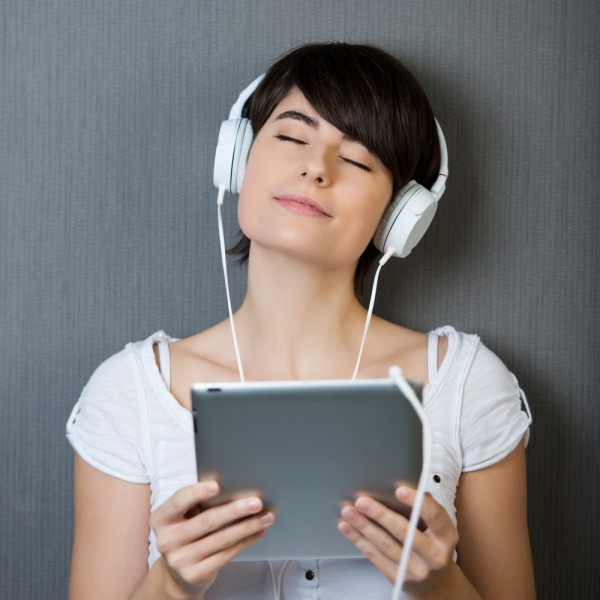 woman listening to music on tablet