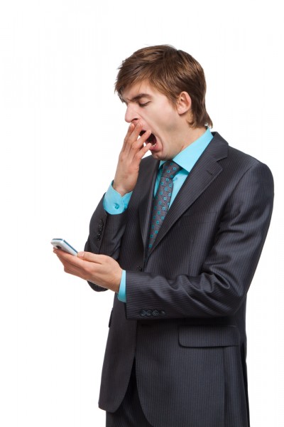 bored businessman on mobile phone