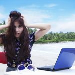 Unhappy laptop user on beach