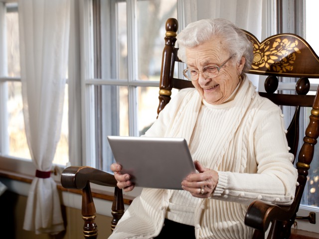 Old elderly woman tablet