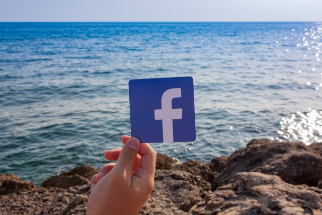 Facebook logo by the sea