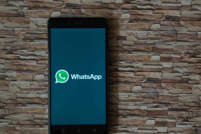WhatsApp on a phone on a stone background