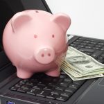 computer piggy bank and cash