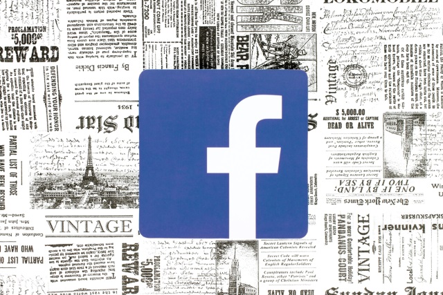 Facebook logo on newspaper background