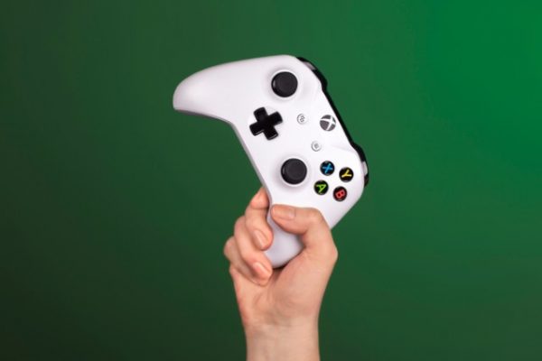 Hand holding an Xbox One controller