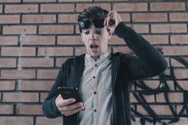 Shocked man looking at phone