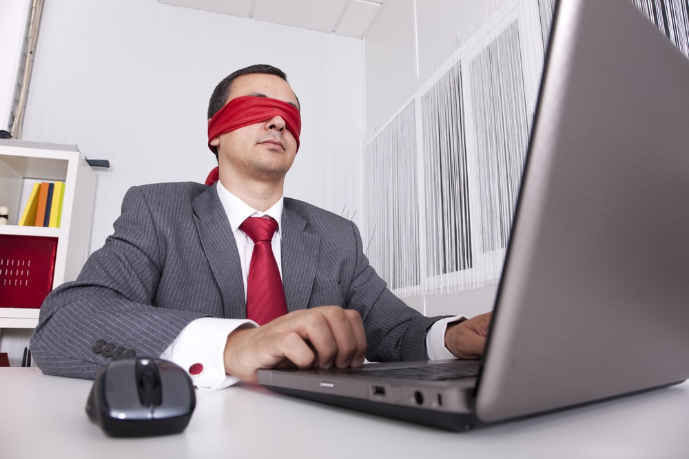 Blindfold businessman laptop