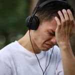 Man crying while listening to music