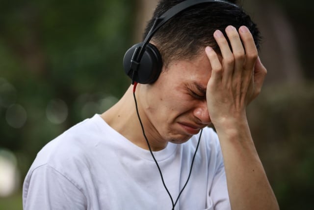 Man crying while listening to music