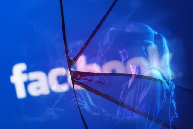 Cracked Facebook logo and metaverse concept