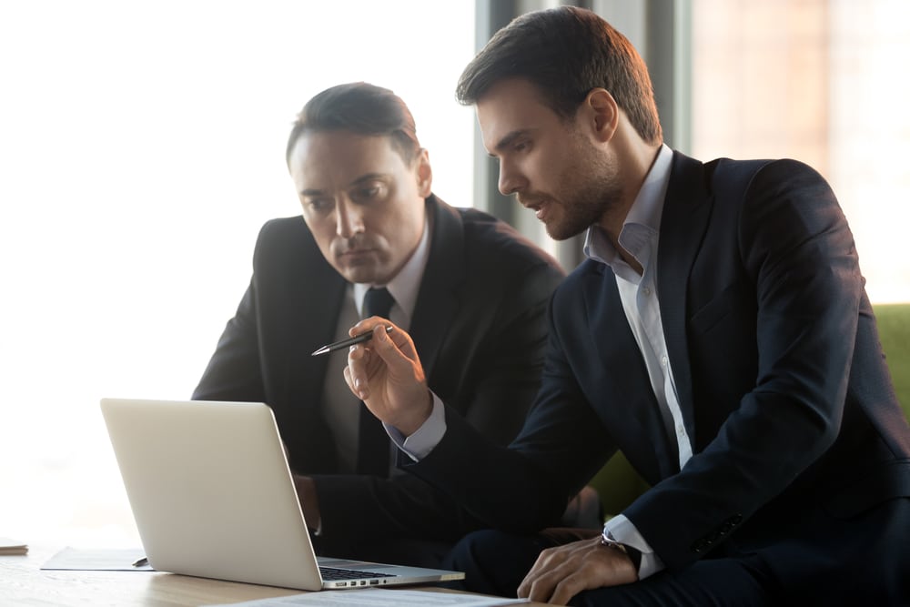 Serious businessmen work together on project