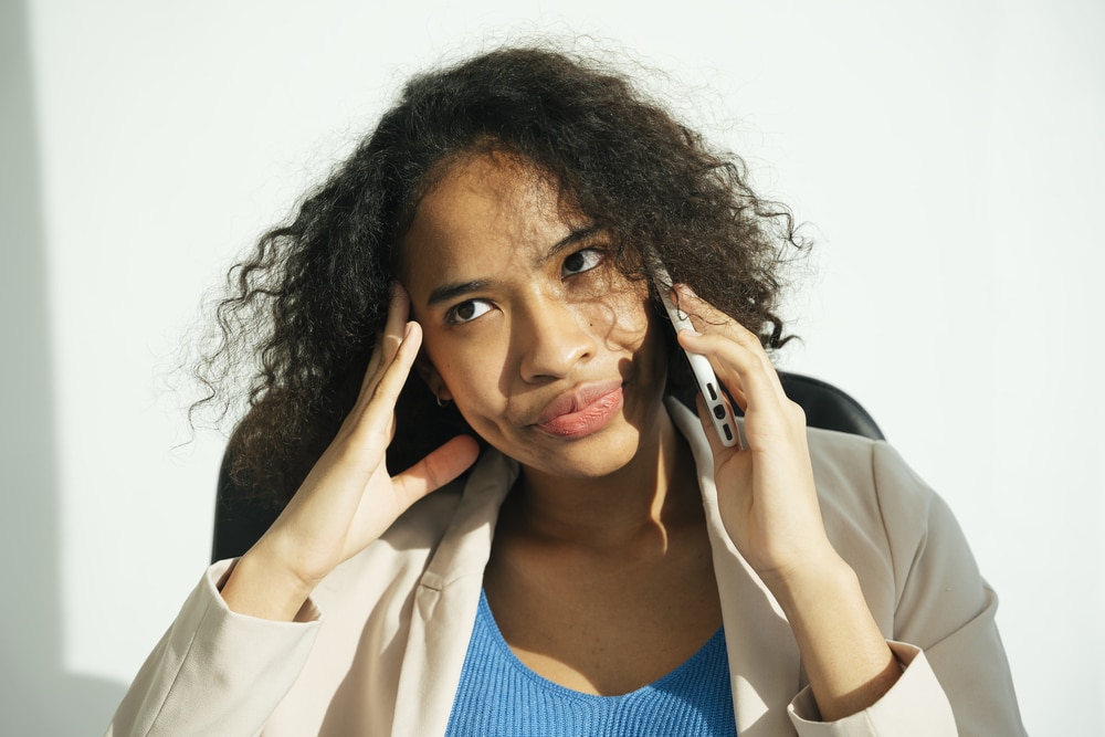 Stressful woman talking on the phone.
