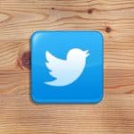 Twitter logo on wooden background