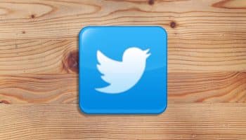Twitter logo on wooden background