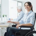 Smiling business woman in wheelchair