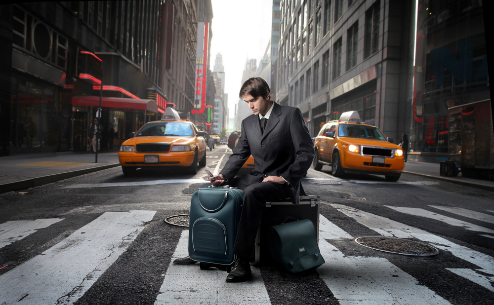 businessman cell phone New York street yellow cab