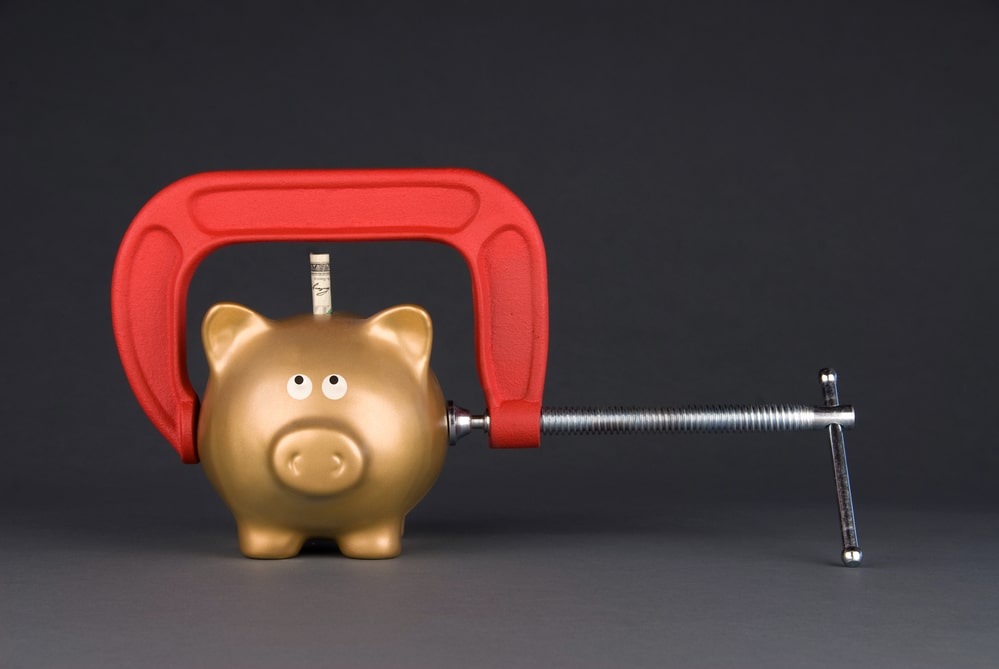 Piggy bank being squeezed