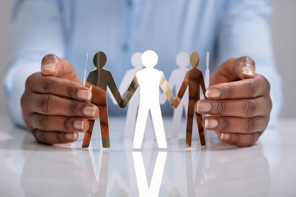 Person Protecting Human Figures Forming Circle