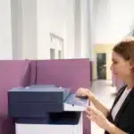 Woman using multi-function printer