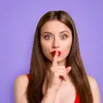 Woman with finger to lips