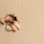 Peeking through hole in cardboard