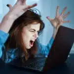 Woman exasperated with laptop