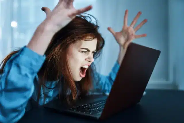 Woman exasperated with laptop