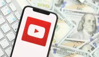 YouTube logo on phone with money in the background