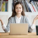 Woman meditating at computer