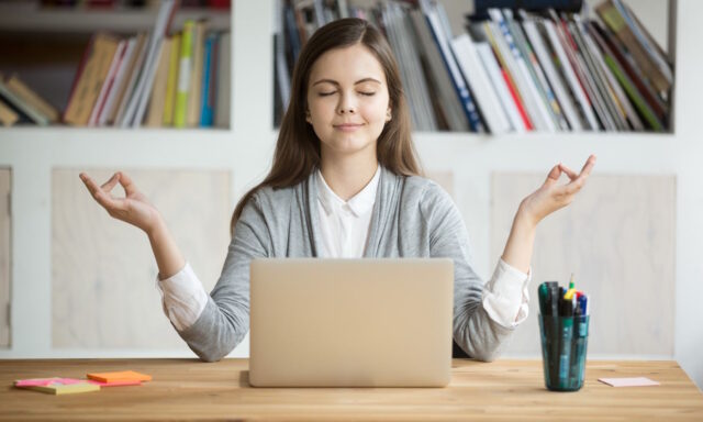 Woman meditating at computer