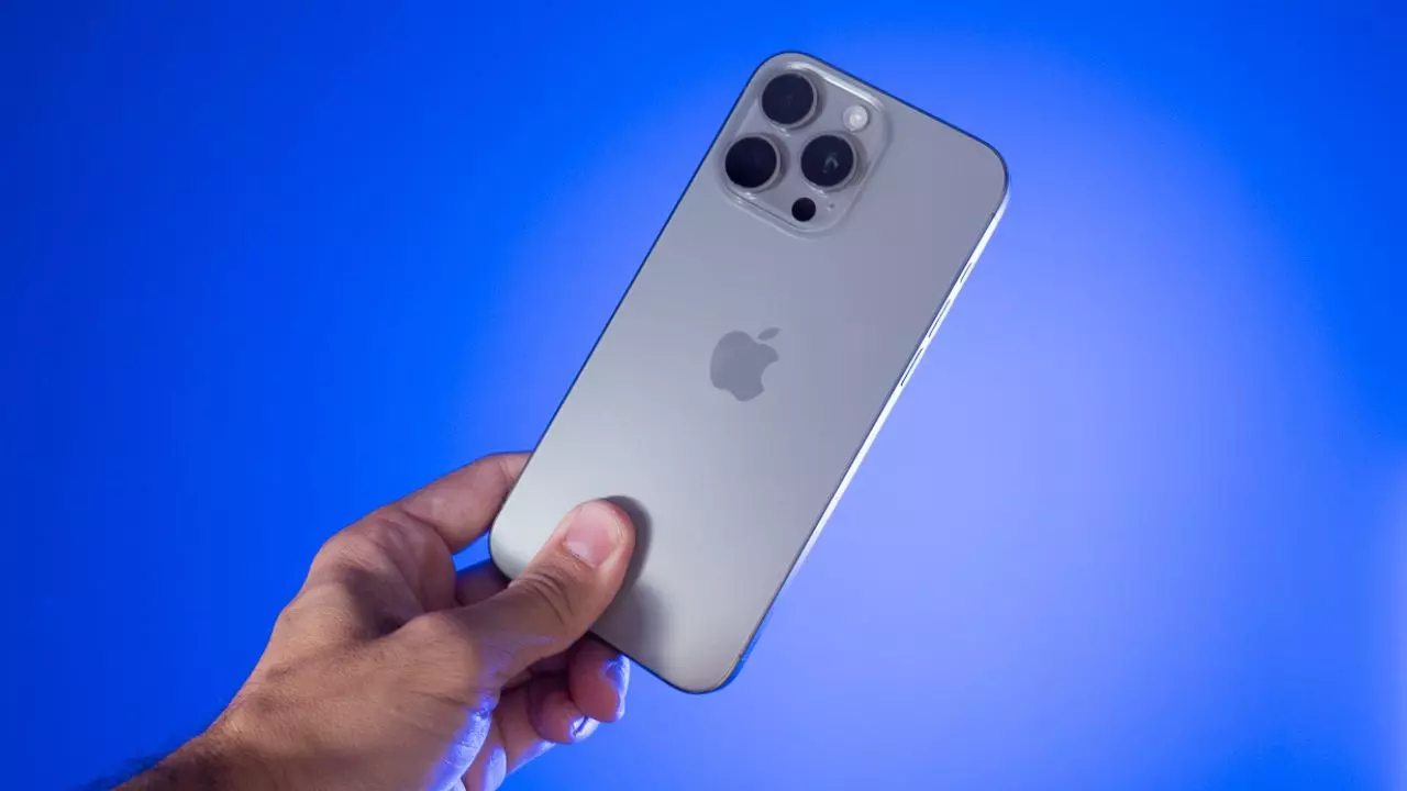 Blue background with a silver iPhone 16 being held in the middle