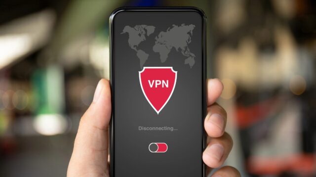 Hand holding phone displaying VPN disconnecting