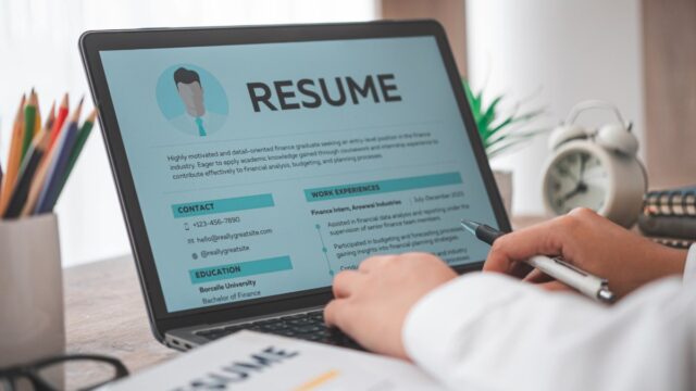 Professional resume on laptop screen.