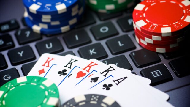 Poker cards and chips on a laptop keyboard