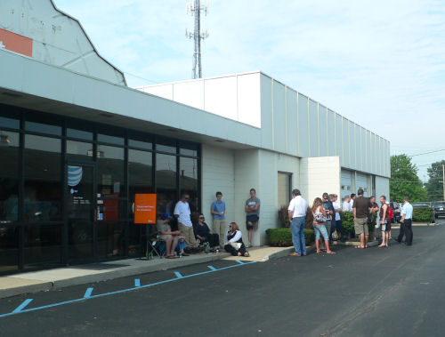 About two dozen people finally formed a line just after a sales clerk hauled out this orange sign.