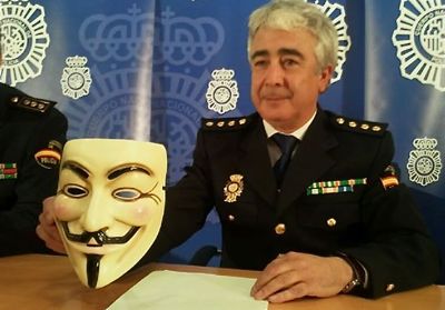 BIT commissioner Manuel Vazquez holds up the trademark Anonymous Guy Fawkes mask