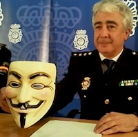 BIT commissioner Manuel Vazquez holds up the trademark Anonymous Guy Fawkes mask 200 pix